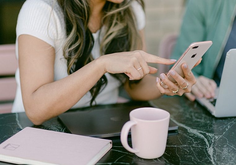 Woman with laptop and phone