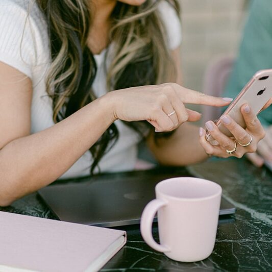 Woman with laptop and phone